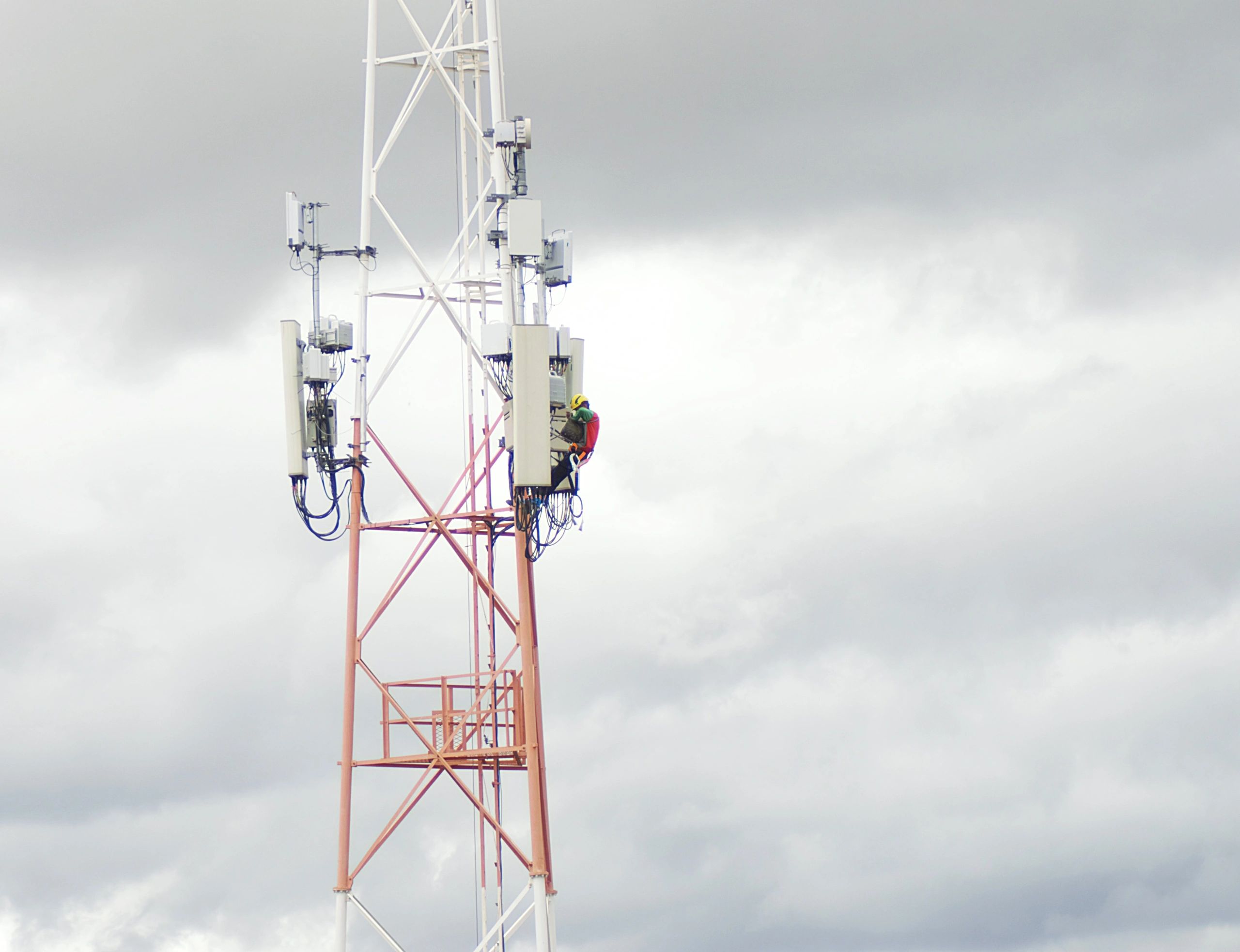 Telecom technician working on transmission tower